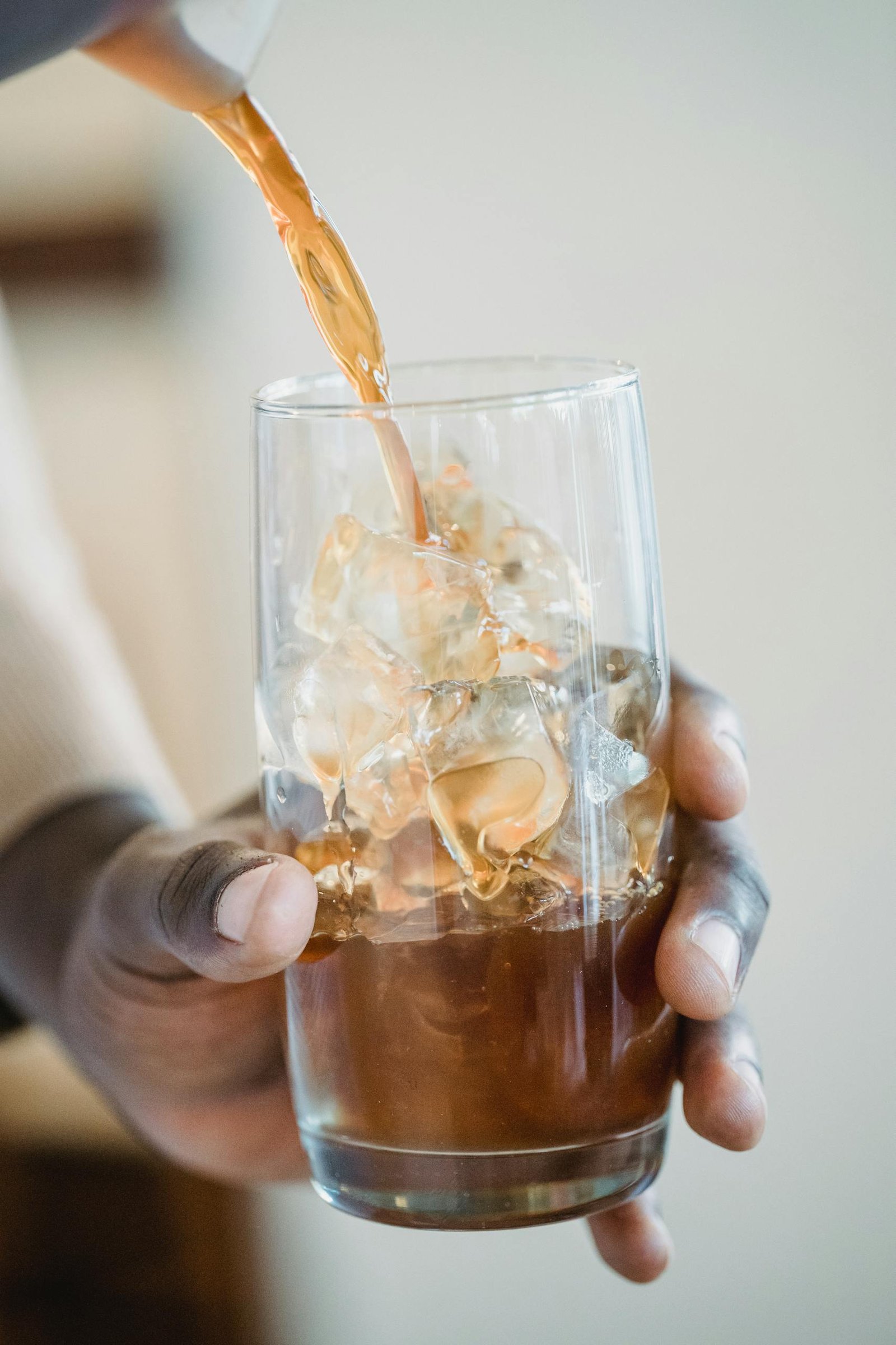 Close Up of Barista Hands Preparing Iced Coffee