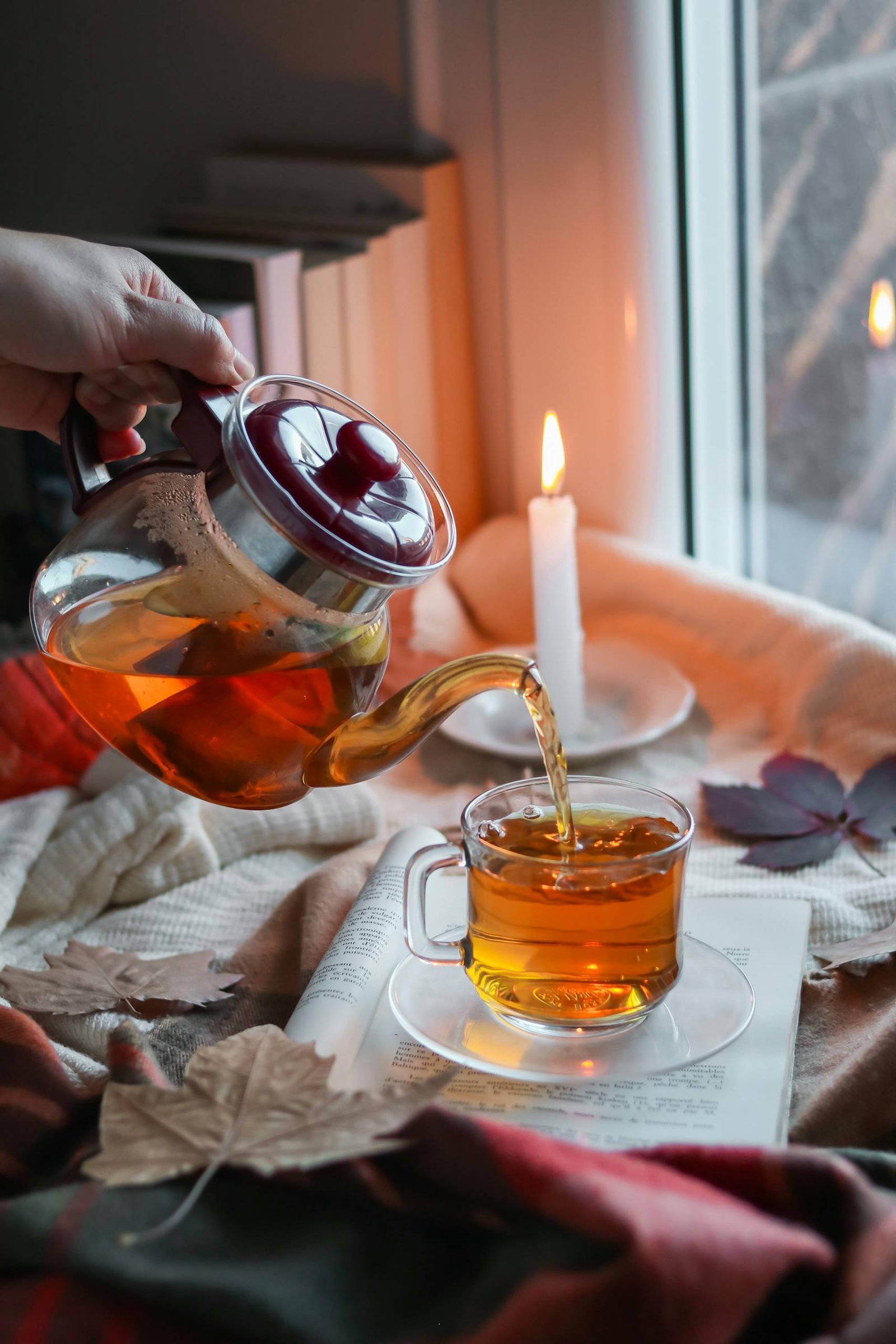 Hand Pouring Tea to Glass